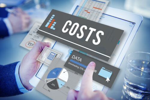 A person holding a tablet considers the price of association management software by consulting graphs and data.